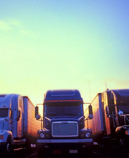 three semi trucks from the front