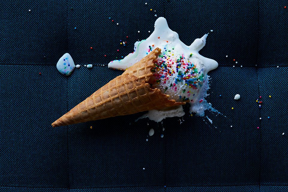 Melting ice cream cone on dark fabric