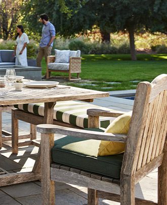 Outdoor seating with people in the background on a lawn