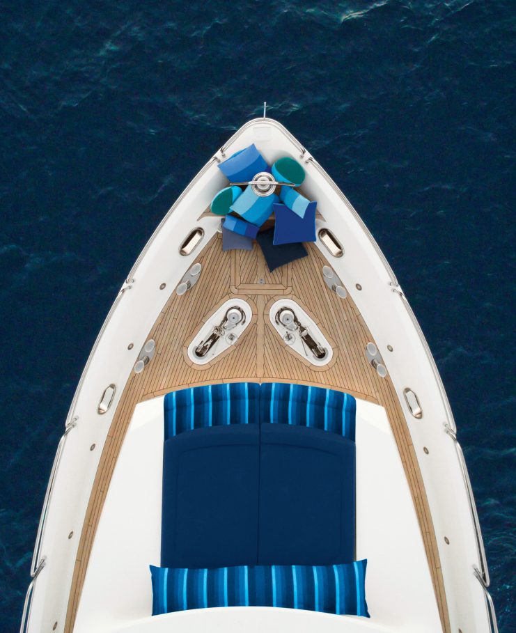 Birds eye view of a boat on the ocean with Subrella pillows and fabric.
