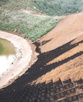 a steep dirt hill leads to a body of water