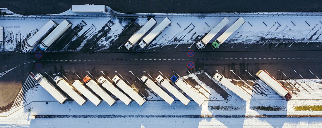 many parked semi trucks shot from above