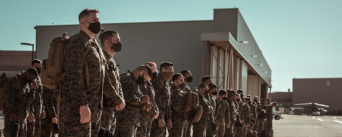 soldiers in uniform and masks stand in a line