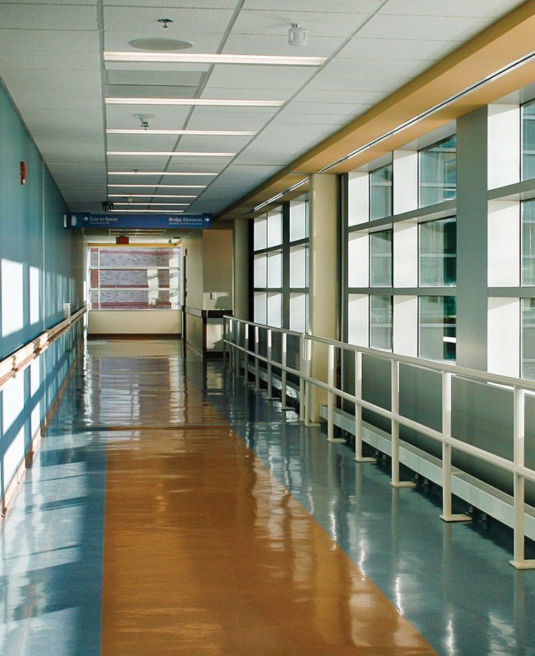 a hallway lined with a railing and windows