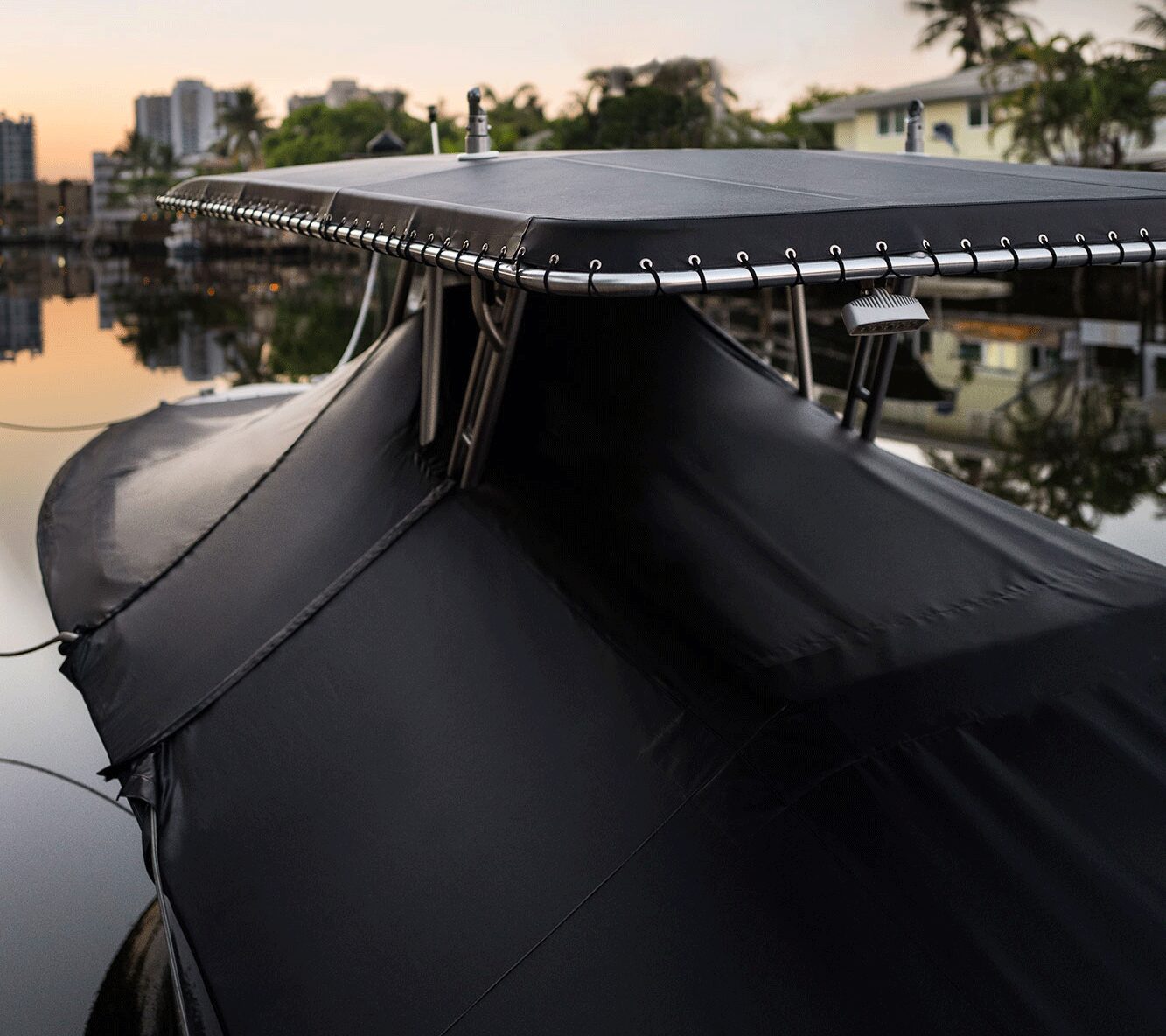 a covered luxury boat at the dock