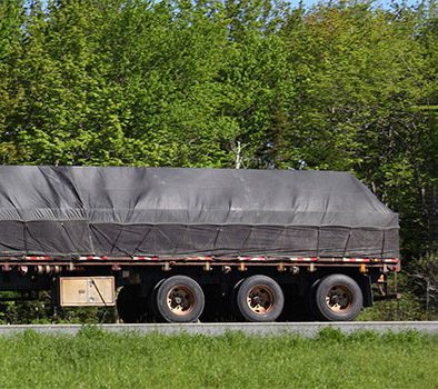 a semi truck with black covering