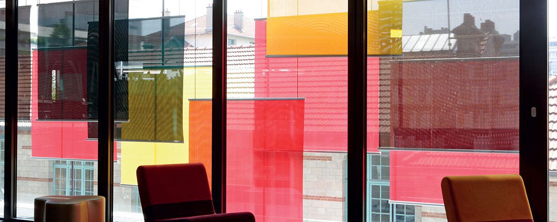 squares of red and yellow window covering fabric visible through windows