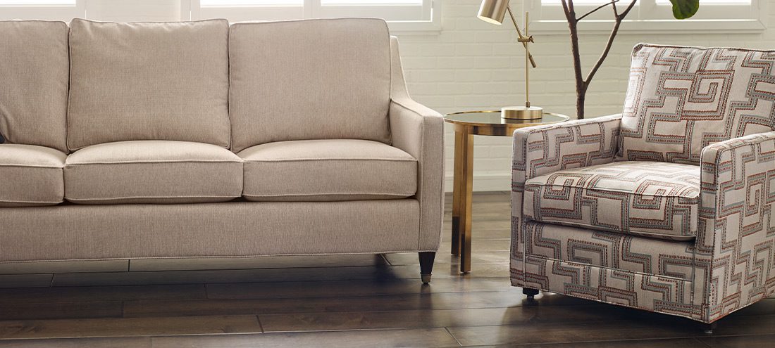 a beige couch and a beige armchair with a maze pattern