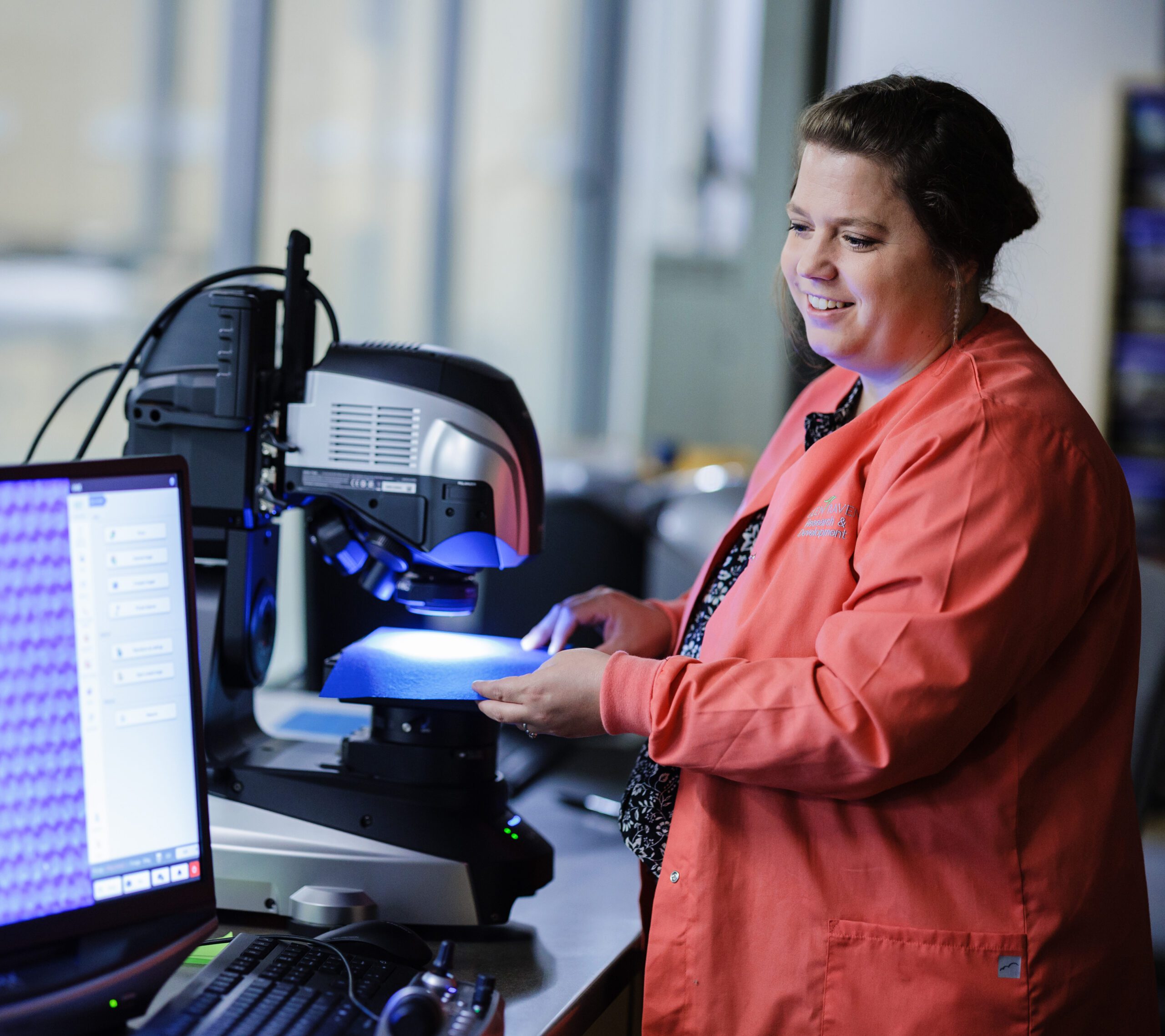 a woman in orange uses a machine