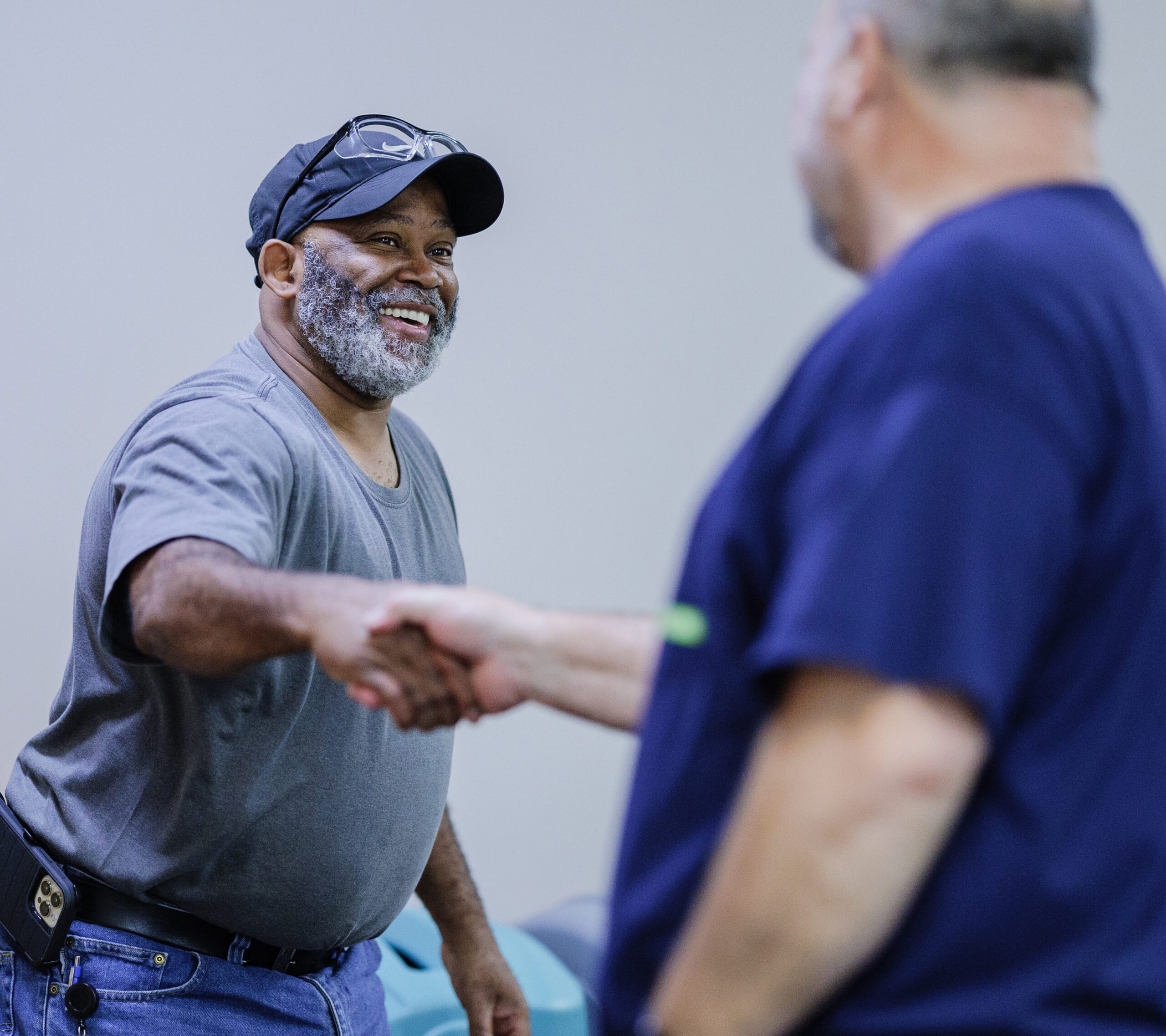 Leib Oehmig shakes hands with a worker