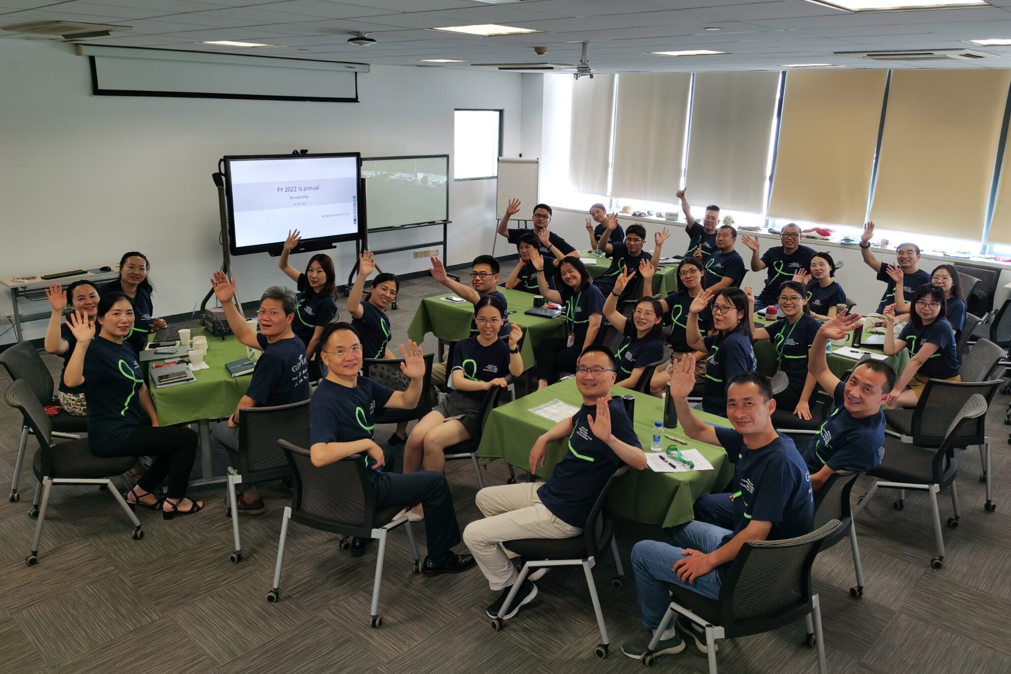 many Glen Raven employees wave from tables