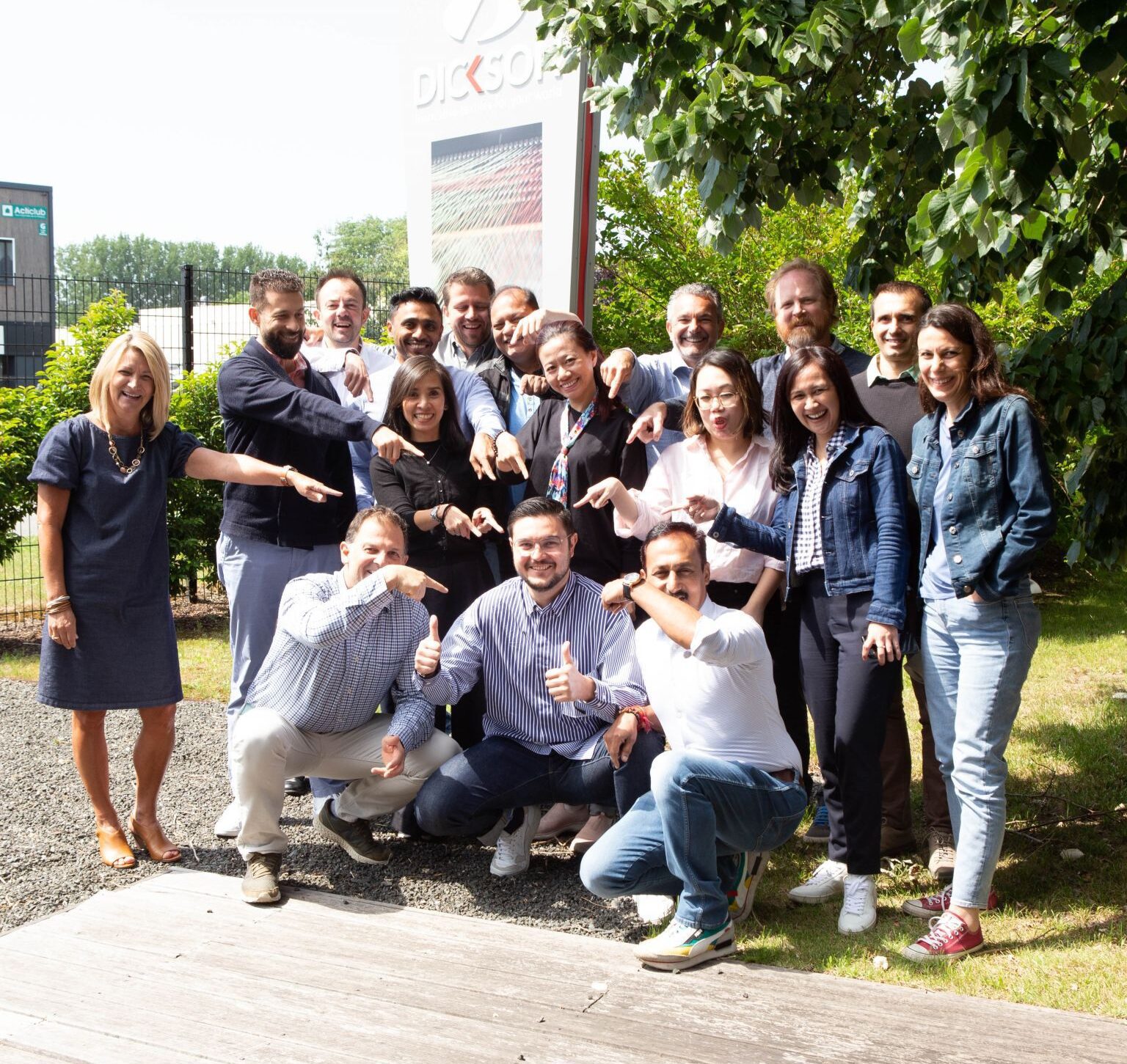 Dickson team poses in front of Dickson building