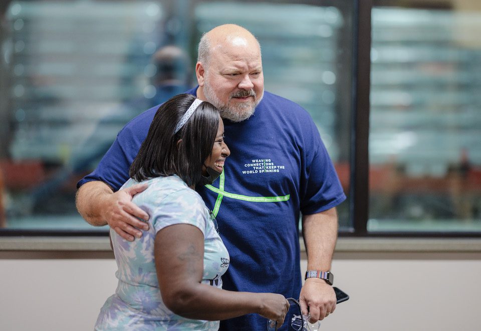 Leib Oehmig hugs a woman