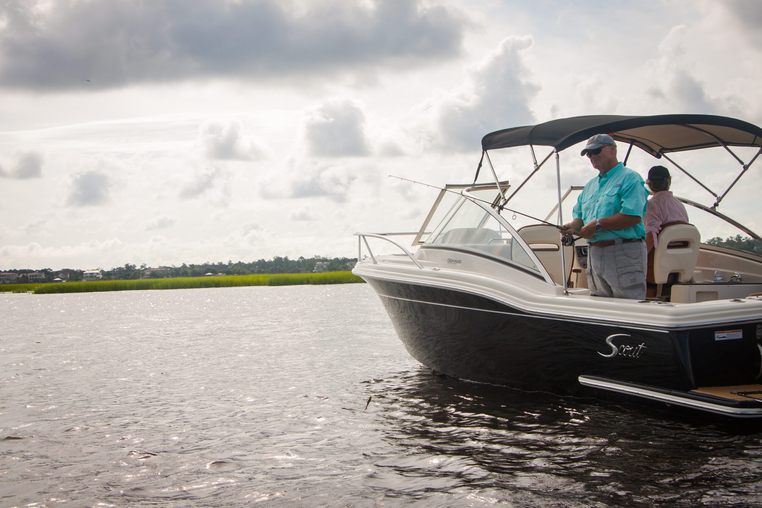 man fishing from boat