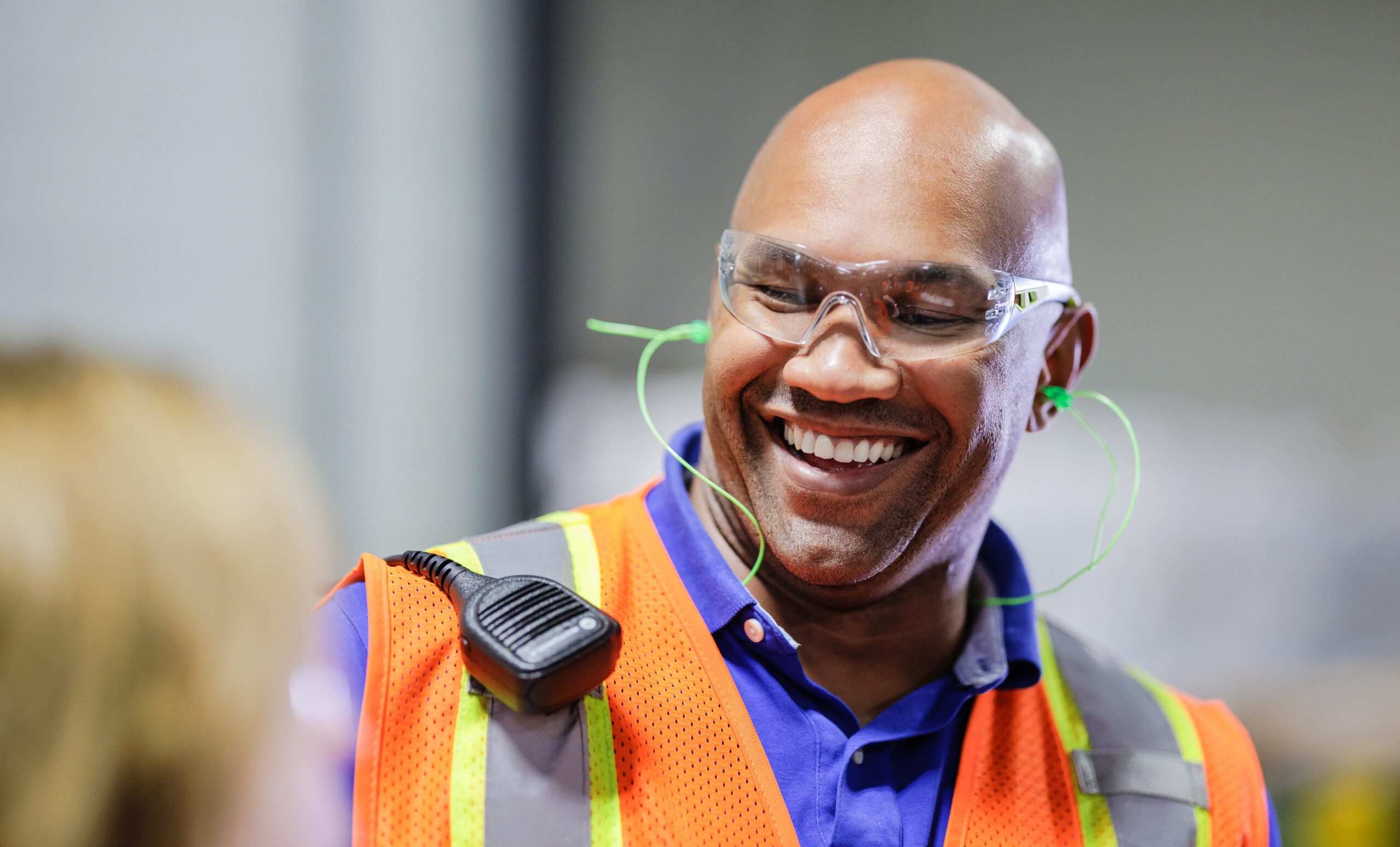 smiling male employee wearing safety glasses