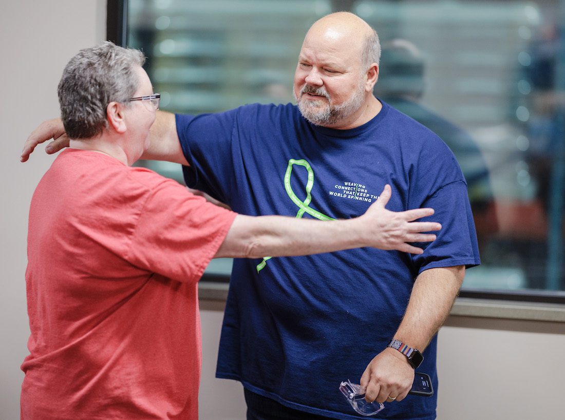 CEO Leib Oehmig hugs a woman